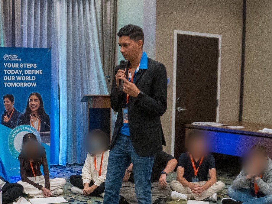 Mau leading a session with students seated in a circle